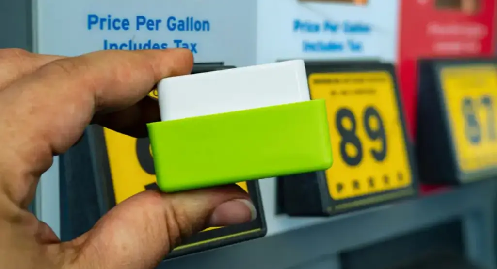 man holding Fuel Save Pro in his fingertips